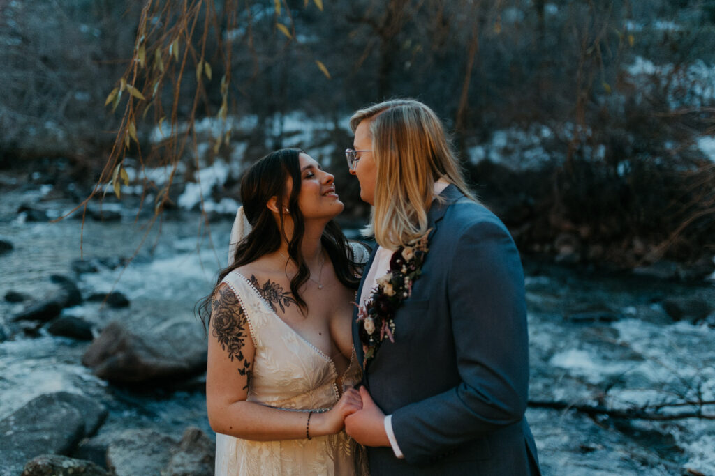 Couple Posing by Boulder Creek after their wedding ceremony at Boulder Creek by Wedgewood Weddings