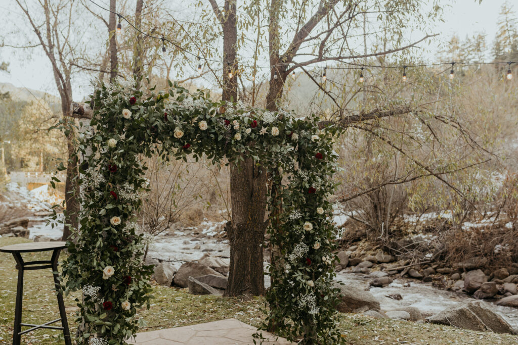 Wedding Ceremony Flower Arch in front of Boulder Creek before the wedding