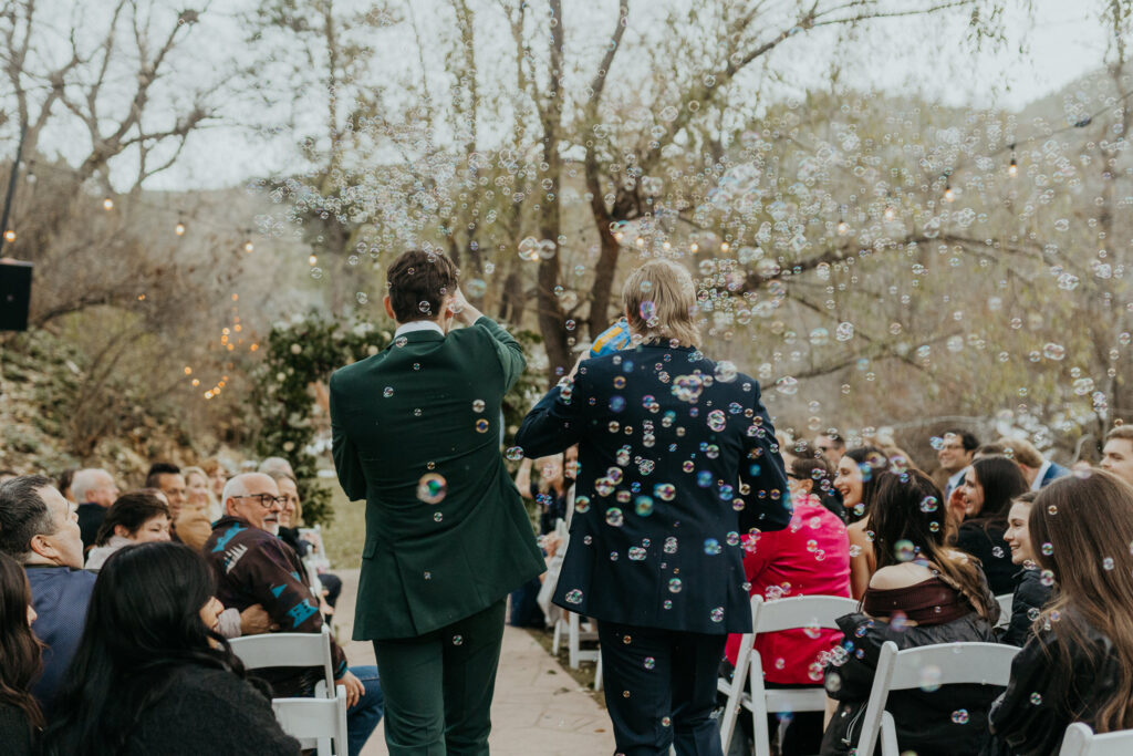 Wedding Party walking down the aisle with bubble-guns giving the crowd a beautiful surprise at Boulder Creek by Wedgewood Weddings