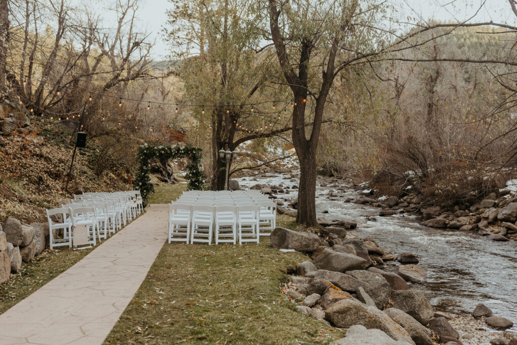 Empty ceremony site with chair setup at Boulder Creek by Wedgewood Weddings from a distance