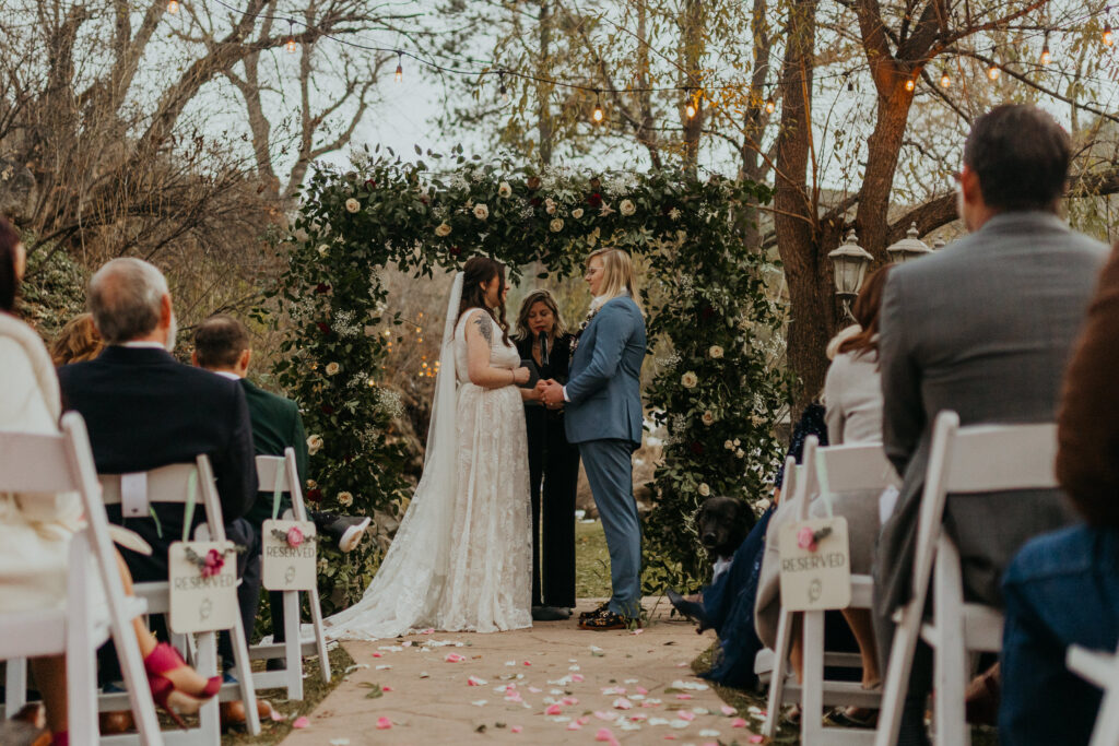 Couple standing in front of the flower archway at Boulder Creek by Wedgewood Weddings during their ceremony