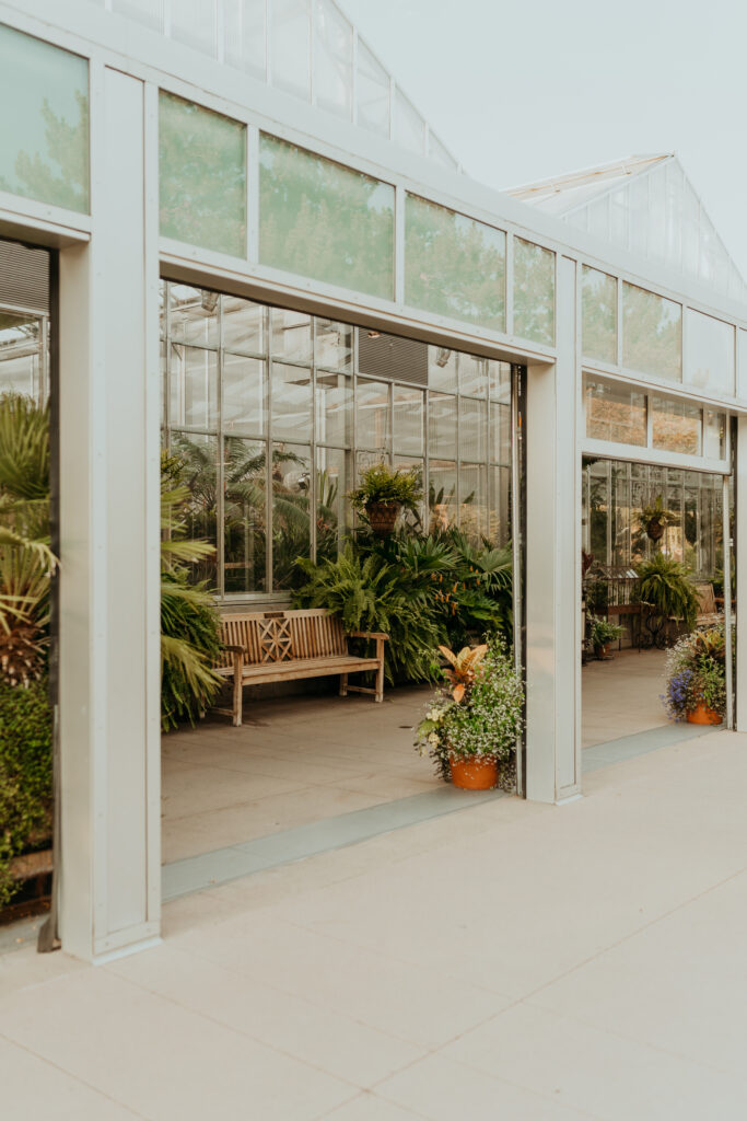 The exterior of the Orangery at the Denver Botanic Gardens at sunset in the summer